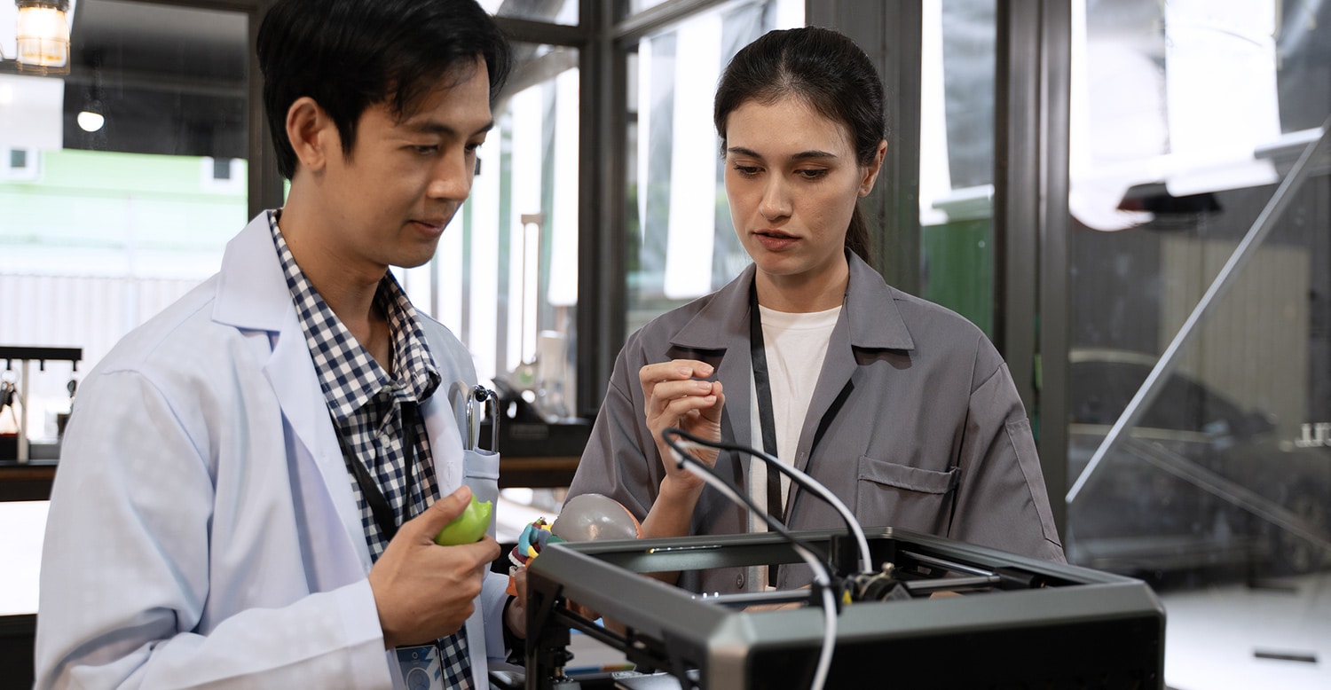 Two individuals testing an equipment design